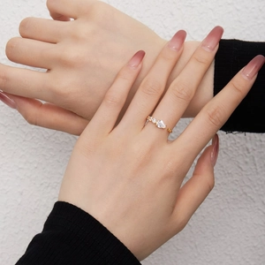Detailed close-up of an adjustable gold vine ring with pear-cut cubic zirconia stones