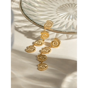 Close-up of gold stainless steel long tassel earrings with four spiral shell links