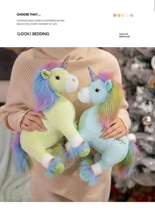 Detail of light green and blue plush unicorns with rainbow manes and glitter horns