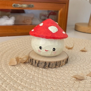 Detailed view of a hand-carved wooden mushroom figurine with a cute smile on wood base