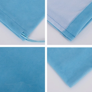 Detail view of blue velvet drawstring jewelry pouch showing stitching and ribbon closure