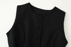Close-up of crew neck and single-breasted fabric buttons on a black sleeveless dress