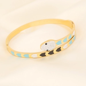 Gold snake-shaped cuff bracelet with white rhinestones and blue heart patterns