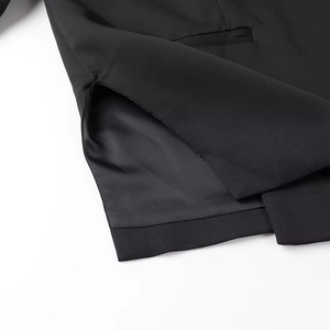 Close-up of side pocket and neat lining on a black oversized blazer for women