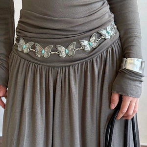 Bohemian butterfly waist chain with turquoise stones on a dark grey pleated dress