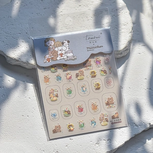 Detail of laser iridescent Tomoni nail art stickers with cute cartoon bear and girl motifs