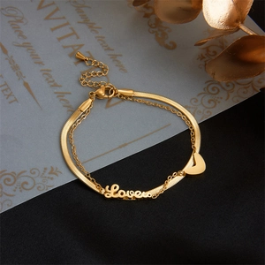 Double-layered gold chain bracelet with Love lettering and a solid heart pendant charm