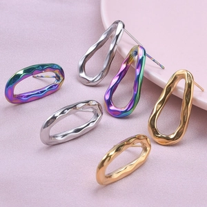 Irregular hammered stainless steel oval earrings in gold, silver, and rainbow finishes