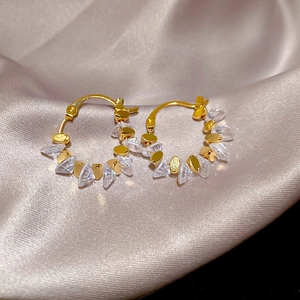 Detailed macro view of 18k gold-plated geometric hoop earrings with crystal studs