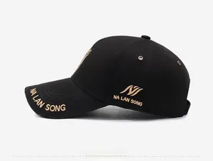Side view of black baseball cap with gold embroidery and metal ventilation eyelets