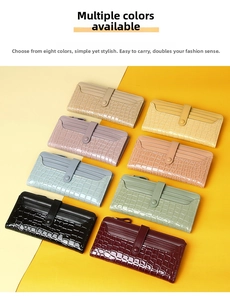 Flat lay of crocodile embossed long wallets in eight vibrant colors with snap closures