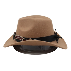 Detail of camel wool fedora hat featuring vintage metal ornament and black band trim