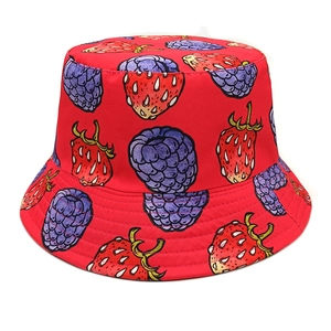 Close-up of vibrant red bucket hat fabric showing detailed strawberry and berry prints