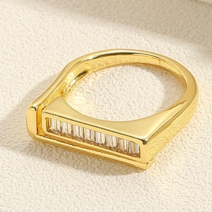Close-up of golden double-layer ring featuring clear rectangular zircon stones setting