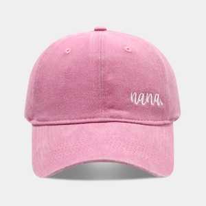Pink washed cotton baseball cap featuring white nana embroidery and curved brim