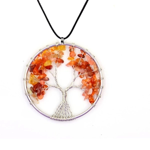 Detail of silver wire wrapped Tree of Life pendant with vibrant orange natural stones