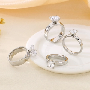 Set of four silver zircon rings with polished and hammered bands on champagne silk