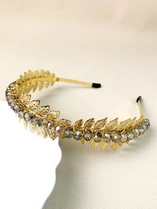 Detailed close-up of handmade golden leaf headband with faceted grey crystal beads