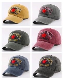 Detail of vintage washed cotton baseball caps showing HILARITY embroidery in multiple colors