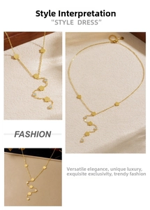 Detail of gold-plated Y-shaped necklace featuring flower charms and clear zircon stones