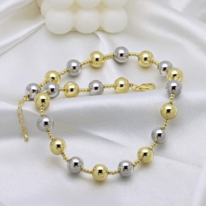 Fashionable two-tone 18k gold and silver bead chain necklace on white silk background