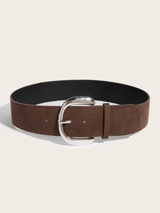 Macro shot of dark brown suede wide belt with polished silver horseshoe buckle