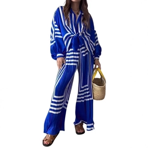 Detailed view of blue and white striped pleated wide leg pants with silky texture