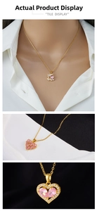 Macro detail of gold heart pendant necklace with pink stones and bow-tie accents