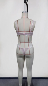 Rear view of pink lace bra set featuring thin adjustable straps and single hook closure