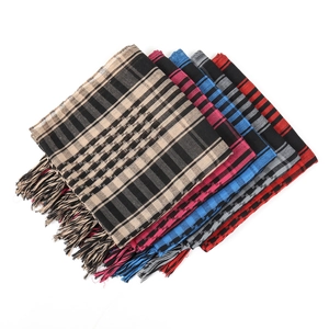 Close-up of stacked houndstooth tactical desert scarves with fringes in various colors