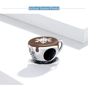 Detailed close-up of a 925 silver coffee cup charm with brown enamel latte art for DIY jewelry