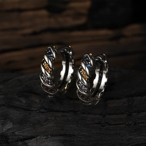 Detailed close-up of vintage silver twisted earrings featuring colorful rainbow zircon stones