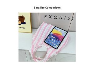 Pink striped puff shoulder bag shown with tablet to demonstrate large storage capacity