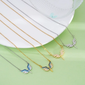 Titanium steel angel wing heart necklace with gold and silver tones and blue zircon