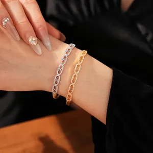 Elegant gold and silver bangles with C-shaped links and sparkling cubic zirconia stones