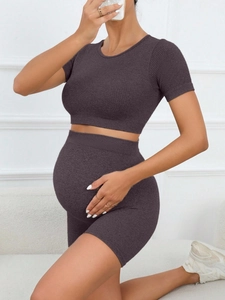 Detailed texture of seamless ribbed maternity yoga set featuring high waist support shorts