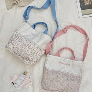 Detailed close-up of floral patchwork canvas tote bags with delicate lace and wide straps