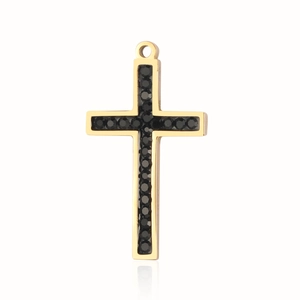 Macro detail of gold-finish stainless steel cross pendant with black gemstone inlay