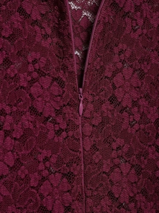 Macro detail of deep purple lace fabric texture and back zipper on lace dress