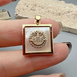 Square gold pendant with shell inlay and sparkling crystal smiley face detail