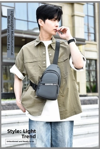Outdoor street shot of dark grey multi-layer waterproof chest bag with adjustable strap