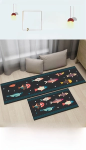 Detail of kitchen mat set with colorful cartoon fish patterns on black non-slip fabric