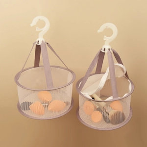 Detail of hanging grey mesh drying nets for beauty blenders and makeup brushes