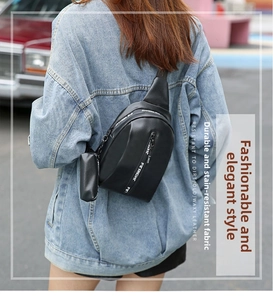 Detail of black leather chest bag with circular coin pouch and branded shoulder strap