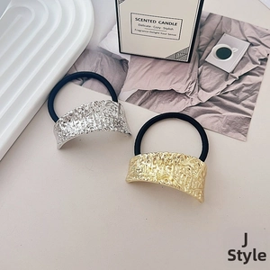 Detail of gold and silver metallic textured elastic hair ties in a stylish set