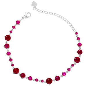 Detail of silver bracelet with red stones, lobster clasp, and heart charm extension chain
