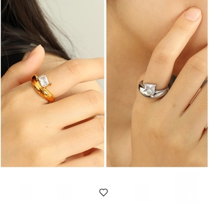 Detailed view of wide irregular 18k gold and silver rings with large zircon gemstone