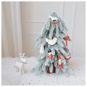 Close-up of a 45cm flocked mini Christmas tree with wooden base and reindeer ornaments