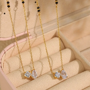 Elegant gold chain necklace with double cubic zirconia pendants in a pink jewelry box