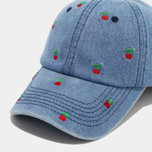 Vintage blue denim baseball cap with all-over cherry embroidery and adjustable strap